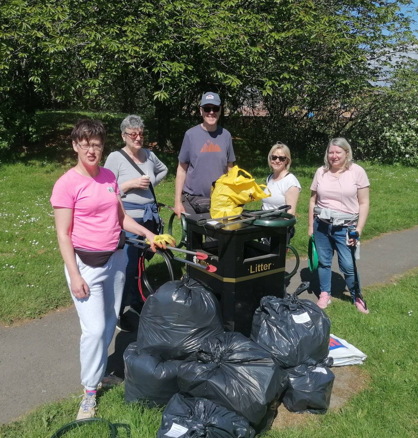 Group of litter pickers with rubbish collected
